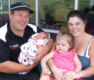 Trent Milne holds new bub Addasyn, while Amiee holds Amberleigh.